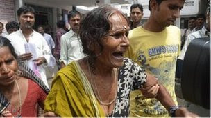 A woman cries after her grandson died at a hospital in the eastern Indian city of Patna July 17, 2013