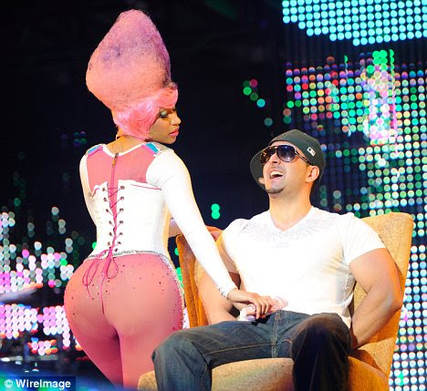 Pink treat: Nicki showed off her voluptuous bottom to fans in New York on Monday in a tight pink and white number