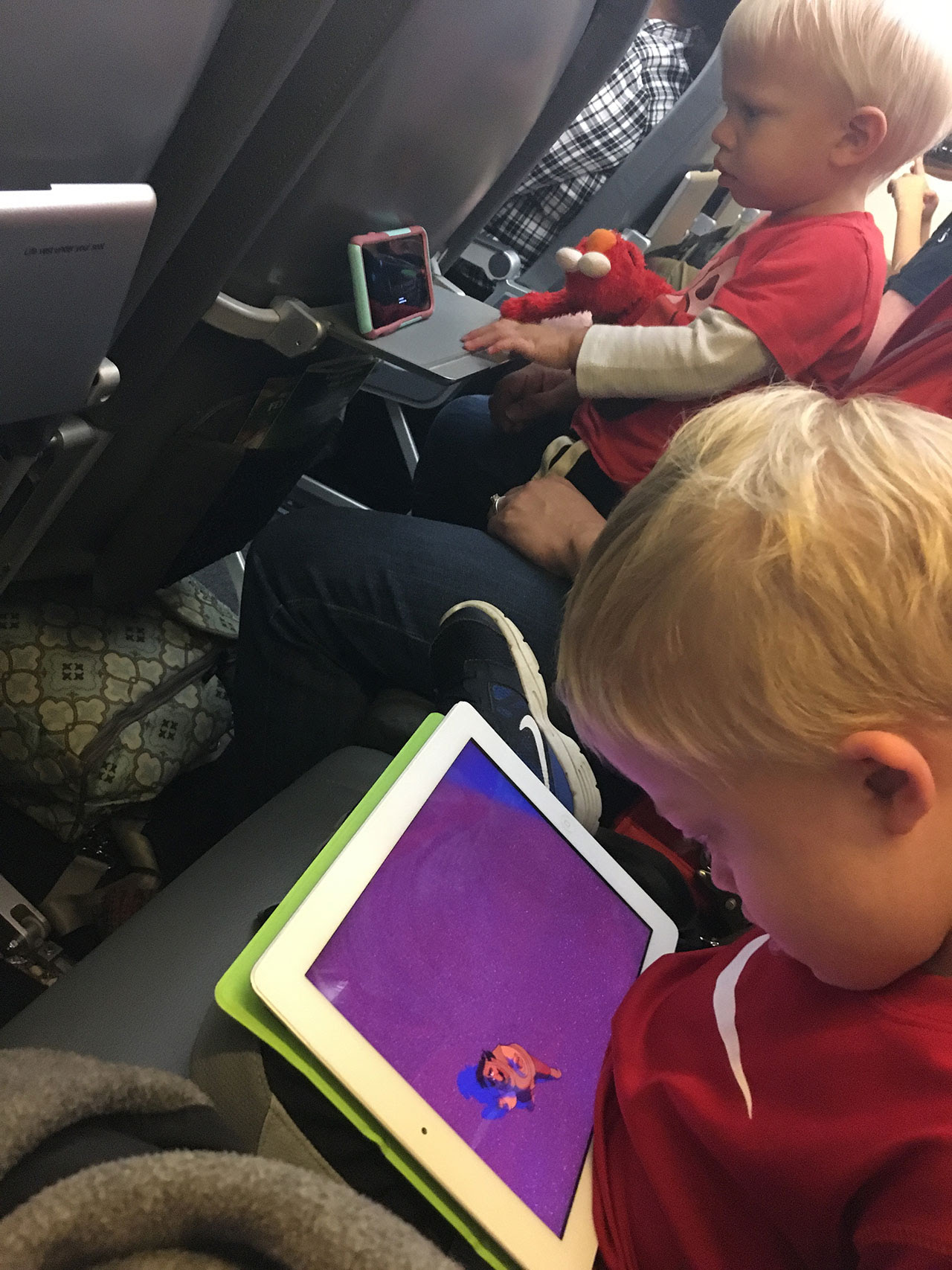 child with down syndrome using iPad on plane