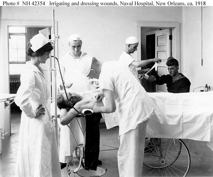 ... and dressing wounds under a Nurse's supervision, circa 1918