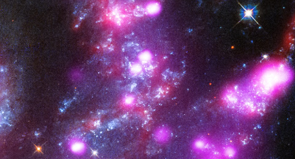 The pink colour in the image shows X-ray emissions from superbright sources (shown up close), believed to be stars around black holes. Intense regions of star formation are also revealed in the image, which uses data from three telescope