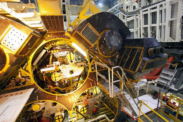 The starboard Orbital Maneuvering System pod is re-attached to space shuttle Discovery on October 28, 2011.