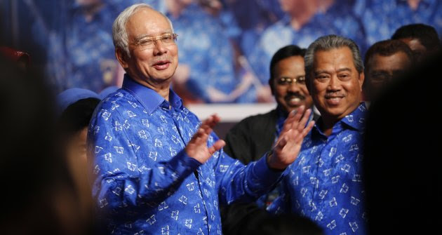 Malaysia's Prime Minister Najib Razak (L) and his deputy Muhyiddin Yassin share a light moment after winning the elections at his party headquarters in Kuala Lumpur early May 6, 2013. Malaysia's governing coalition won a tight national election on Sunday to extend its 56-year rule, fending off an opposition alliance that pledged to clean up politics and end race-based policies in Southeast Asia's third-largest economy. REUTERS/Bazuki Muhammad (MALAYSIA - Tags: POLITICS ELECTIONS)