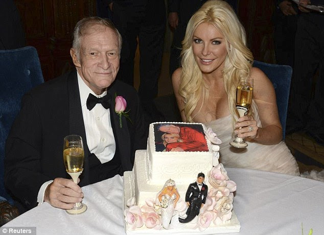 Toasting the future: The pair enjoy a glass of champagne as they celebrate their newlywed status with a cake, complete with picture of the couple on the top