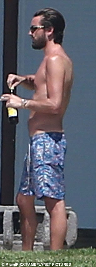 Beer o'clock: The 32-year-old star - who completed a month stint in rehab last year - was seen indulging in a cigarette and a beer as he lay out with the ladies