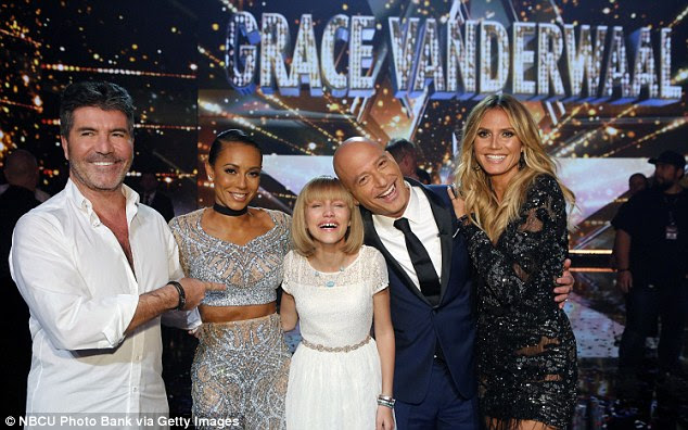 Victory giggles: The little girl was overjoyed to see her name in lights -literally 