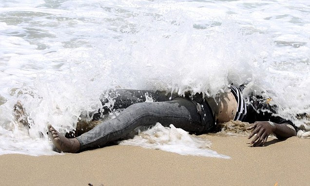 The body of an African would-be migrant washed up on the shore of al-Qarboli in Libya