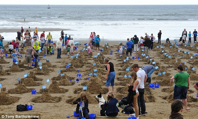 Not the best weather for it: More than 1,000 sandcastles are built on Scarborough beach today in a world-record attempt