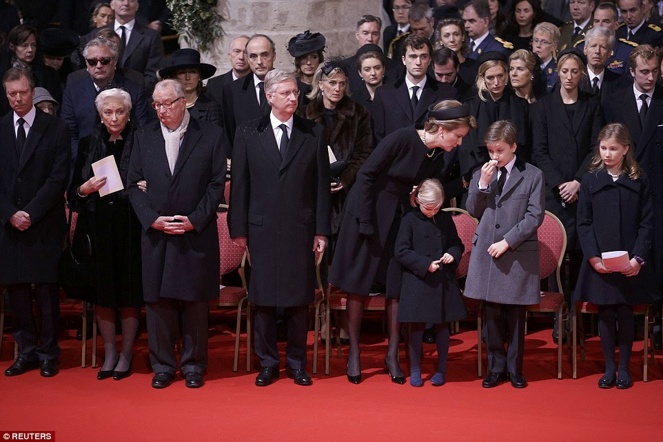 Sad day: The funeral party included former Queen Paola and King Philippe and Queen Mathilde's four young children (right)