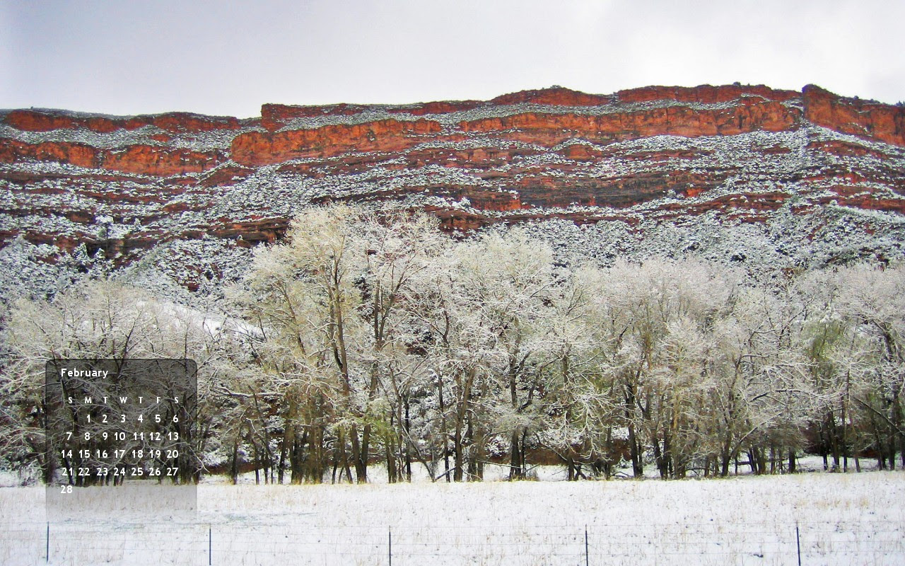 Red mesa and snowy cottonwood trees make up the scenery in this Feb 2010 wallpaper calendar for your computer.