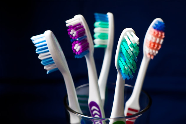 closeup of cup full of toothbrushes