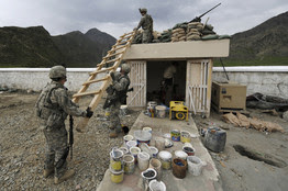 [Soldiers set up a ladder by a watch tower at an operation post]