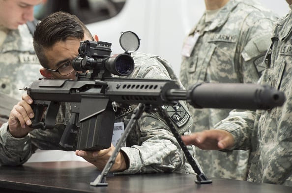A US Army soldier looks over a Barrett M107A1 rifle