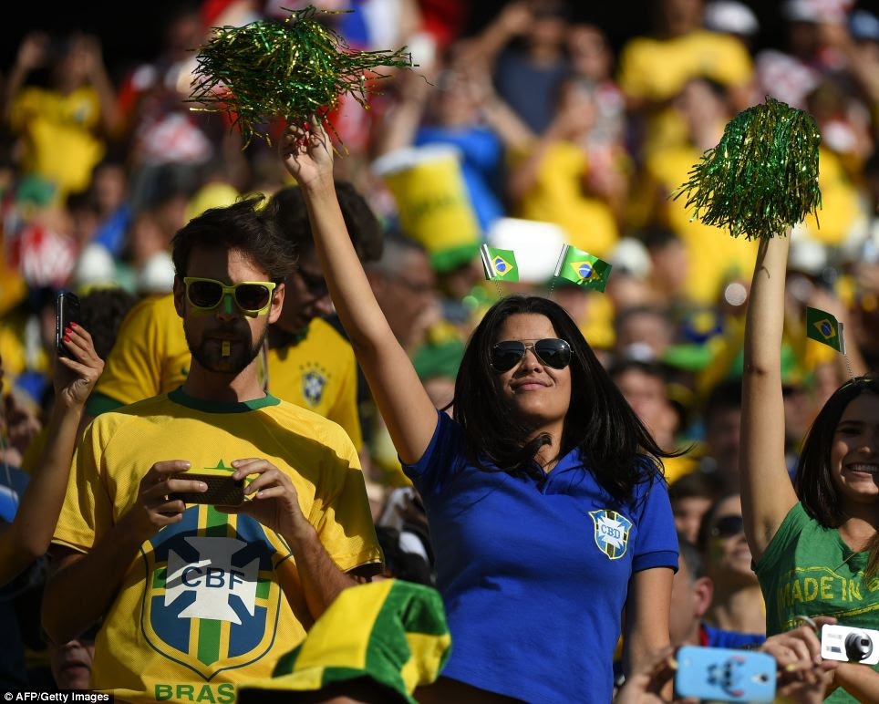 Brazilian fans cheer during the World Cup opening ceremony as they prepare to watch their team kick off the month-long football tournament with the opening Group A match against Croatia