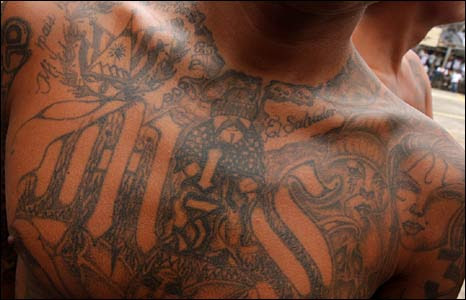 Gang members sport elaborate tattoos as a sign of their allegiance