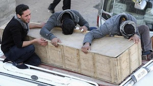 Mourners cry as they hold onto the coffin of their relative, who was killed in an attack in the town of Yusfiya, during a funeral in Najaf, 160 km (100 miles) south of Baghdad