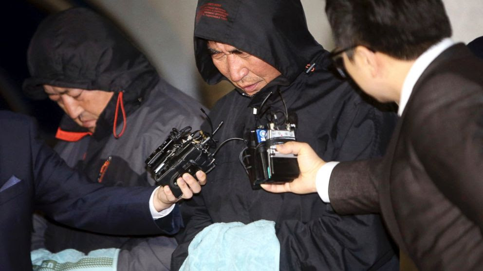 PHOTO: Lee Joon-seok, center, the captain of the sunken ferry Sewol in the water off the southern coast, talks to the media before leaving a court which issued his arrest warrant in Mokpo, south of Seoul, South Korea, April 19, 2014.
