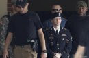 U.S. Army Private First Class Bradley Manning (C) departs the courthouse at Ft. Meade, Maryland