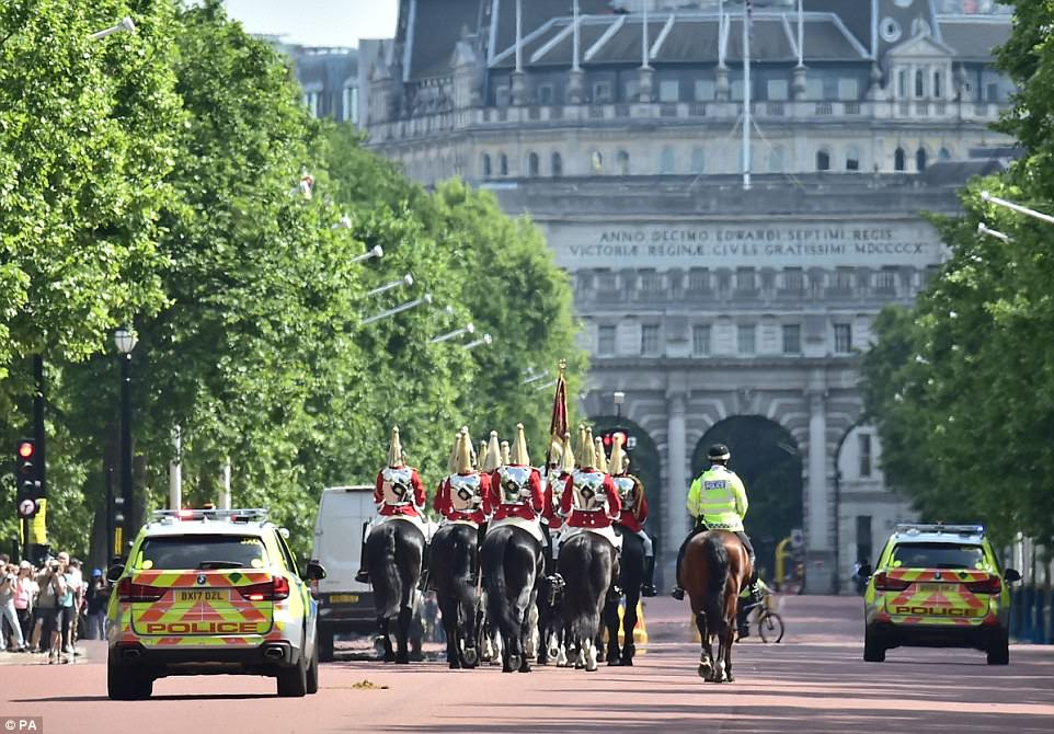 The Changing of the Guard at Buckingham Palace was cancelled along with public tours of the Palace of Westminster.Police escort members of the Household Cavalry along the Mall in central London this morning