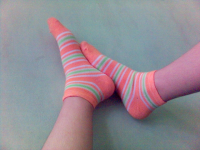 feet in colorful socks, against the wall 2005