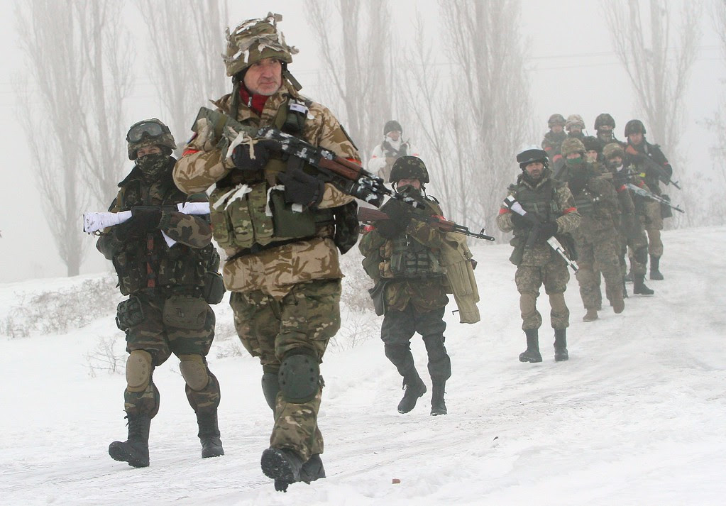 Description of . Ukrainian servicemen of the Donbass volunteer battalion take part in clean-up operations in a village in the Lysychansk district of the Lugansk region, controlled by pro-Russian separatists on January 28, 2015.  Ukraine's president appealed to Russia's Vladimir Putin and Washington threatened tougher measures should Moscow fail to rein in separatist fighters mounting a new offensive in the east of the ex-Soviet republic. ANATOLII BOIKO/AFP/Getty Images