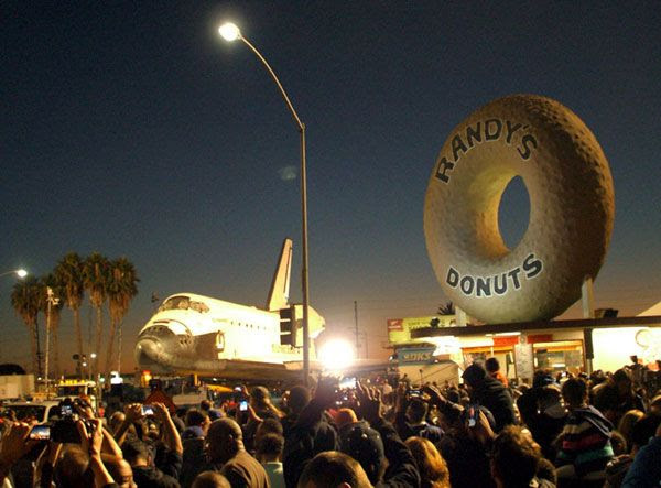 Space shuttle Endeavour is parked on the street near Los Angeles' well-known Randy's Donuts on October 12, 2012.