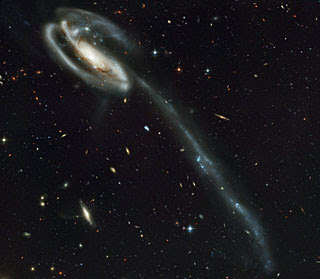 A 'wallpaper' of distant galaxies is a stunning backdrop for a runaway galaxy