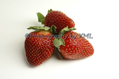 red ripe strawberries against a white background 