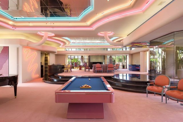 Game room with pink pool table.