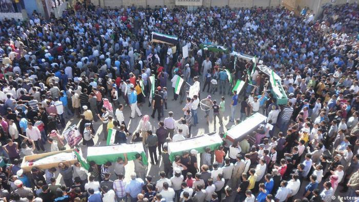 Syrian residents carry the bodies of people whom protesters say were killed by forces loyal to Syria's President Bashar al-Assad, during their funeral in Deraa June 9, 2012. Seventeen people, including 10 women, were killed overnight by shelling in the southern Syrian town of Deraa, where the uprising against President Bashar al-Assad erupted 15 months ago, the Syrian Observatory for Human Rights said.
REUTERS/Handout   (SYRIA - Tags: CIVIL UNREST POLITICS CONFLICT) FOR EDITORIAL USE ONLY. NOT FOR SALE FOR MARKETING OR ADVERTISING CAMPAIGNS. THIS IMAGE HAS BEEN SUPPLIED BY A THIRD PARTY. IT IS DISTRIBUTED, EXACTLY AS RECEIVED BY REUTERS, AS A SERVICE TO CLIENTS