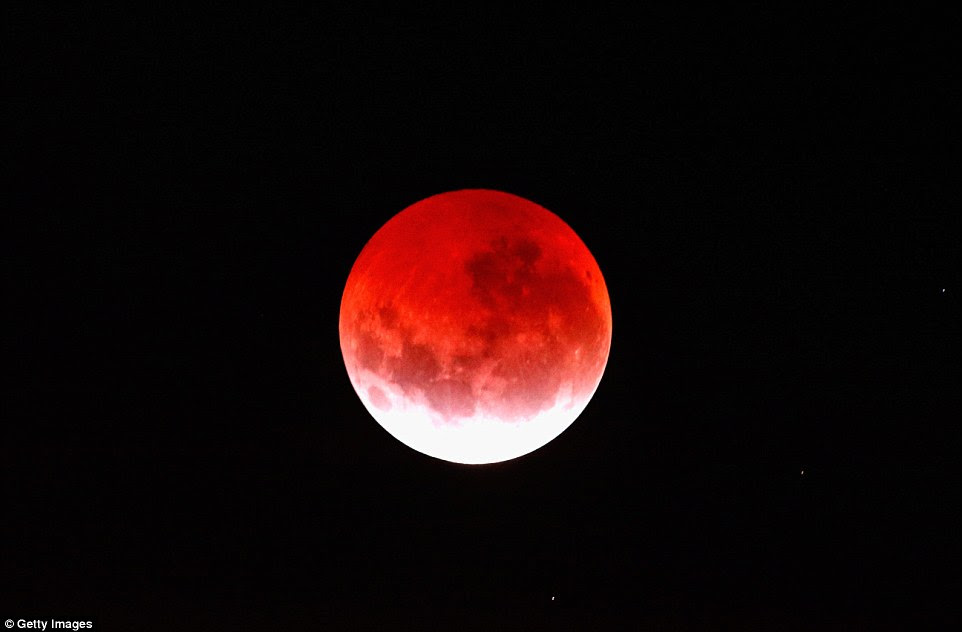 Don't blink! The moon may have shone red for three hours but it was only visible to citizens for five minutes (pictured over New Zealand)