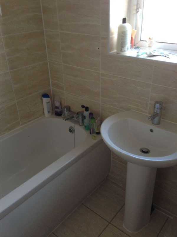 Coventry Bathrooms » Sink fitted to cream tile beneath the window 