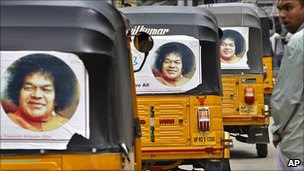 Rickshaws with pictures of Sathya Sai Baba, in Puttaparti, India, April 2011