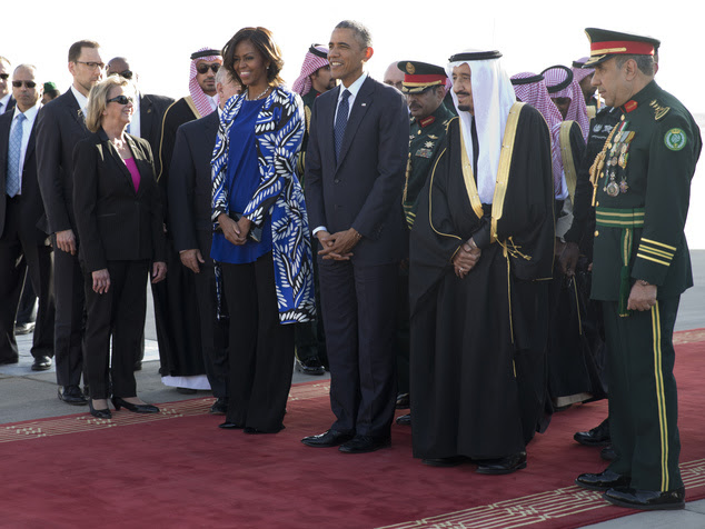 President Barack Obama and first lady Michelle Obama stand with new Saudi King Salman bin Abdul Aziz they arrive on Air Force One at King Khalid International Airport, in Riyadh, Saudi Arabia, Tuesday, Jan. 27, 2015. (AP Photo/Carolyn Kaster)