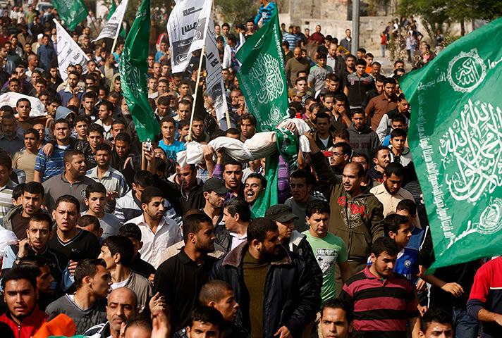 Gaza conflict: Palestinians carry the body of a child  in Gaza City