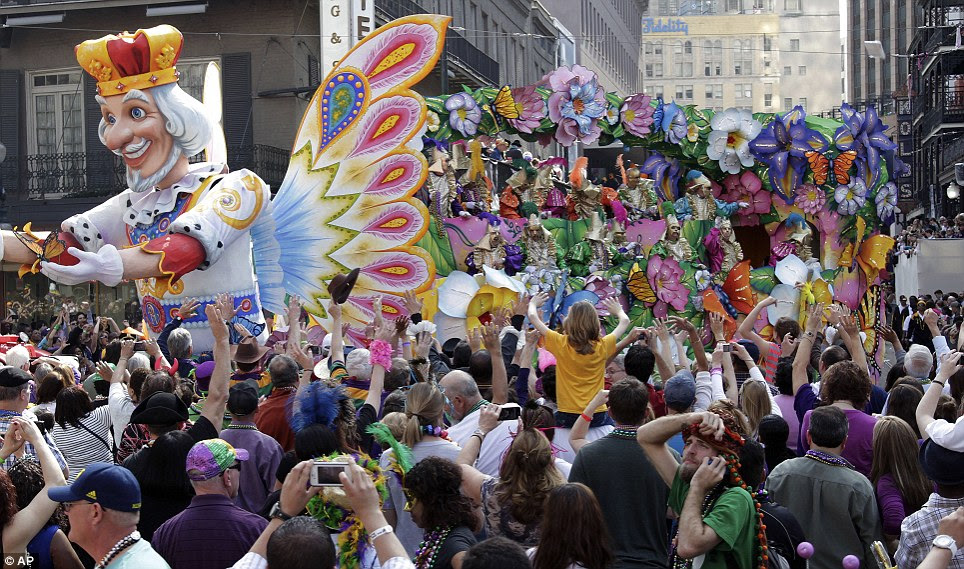 Over here! The float takes a wide turn as revellers shout in hopes of catching a toss