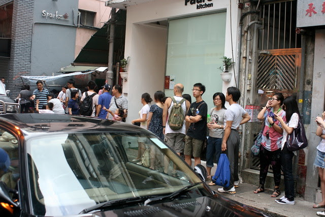 Queueing up for tomato broth noodles with beef, toast with condensed milk