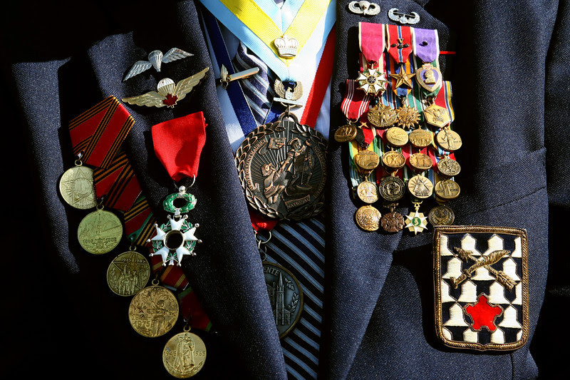 Description of  A US veteran wears his medals during a commemoration ceremony on June 5, 2009 at the German Military Cemetery of La Cambe, Normandy. Preparations are underway for the upcoming D-Day celebrations to mark the 65th anniversary of the June 6, 1944 allied landings in France, then occupied by Nazi Germany. US President Barack Obama is to lead commemorations attended by thousands of Americans on June 6 at the ceremony above Omaha Beach, where more than 9,000 US troops fought and died in June 1944. (JOEL SAGET/AFP/Getty Images)