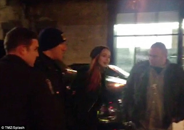 Handcuffs: Lindsay Lohan is led away from Avenue nightclub in handcuffs by police in the early hours of Thursday morning 