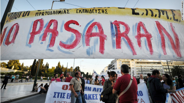 Anti-austerity protesters gather behind a banner in central Athens on May 22, 2012.
