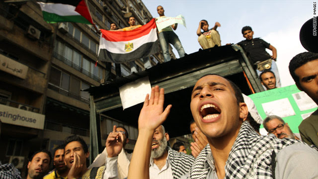 Students wave Palestinian and Egyptian flags by Cairo's Israeli embassy, on April 27, to protest Egypt's gas exports to the state.