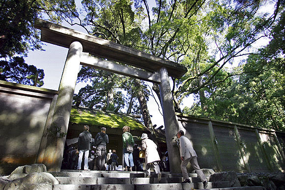 eople walk through a wooden torii gate to pay their respects at Ise Jingu, Japan's oldest and most important Shinto shrine, in Ise, western Japan November 7, 2006. Thousands of worshippers across Japan visit the 2000 year old Ise Jingu, which enshrines Amaterasu Omikami, sun goddess and the ancestral goddess of the Imperial family.