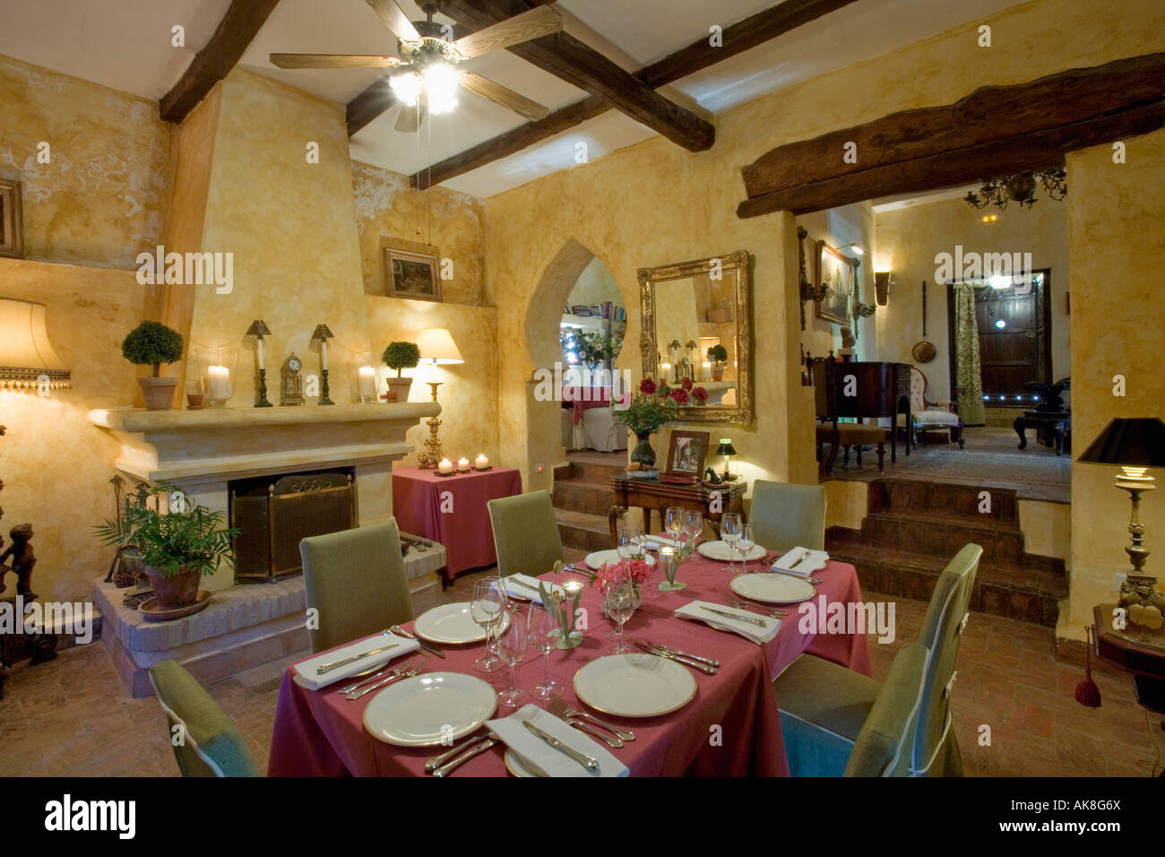 White Crockery And Red Cloth On Table In Yellow Dining Room In