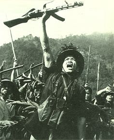 An officer of Viet Cong bracing a soldier up. 1966.