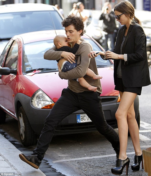 Good genes: Miranda, husband Orlando Bloom and ten-month old son Flynn strolled through Paris in late September