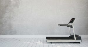Treadmill in interior room at home in front of concrete wall (3D Rendering)