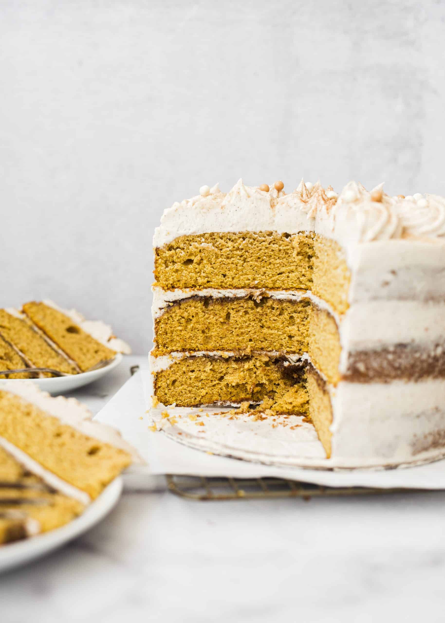 Pumpkin Layer Cake by Wood and Spoon blog. This is a fluffy and moist pumpkin cake layers with cinnamon sugar buttercream. This dessert is a spiced cake perfect for fall or winter holidays. To learn how to make a festive cake for thanksgiving or fall, check out the recipe and how-to on thewoodandspoon.com