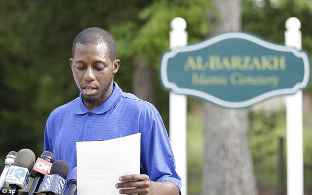 Vice President of the Islamic Funeral Services of Virginia, Bukhari Abdel-Alim, reads a statement at the entrance to the Al-Barzakh Islamic Cemetery 