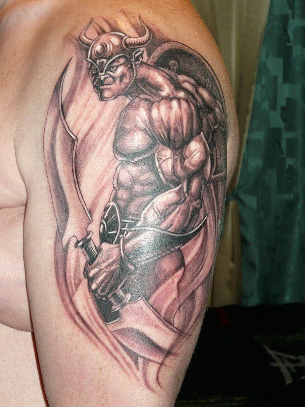 Beefy warrior with two-sided sword tattoo on shoulder ...