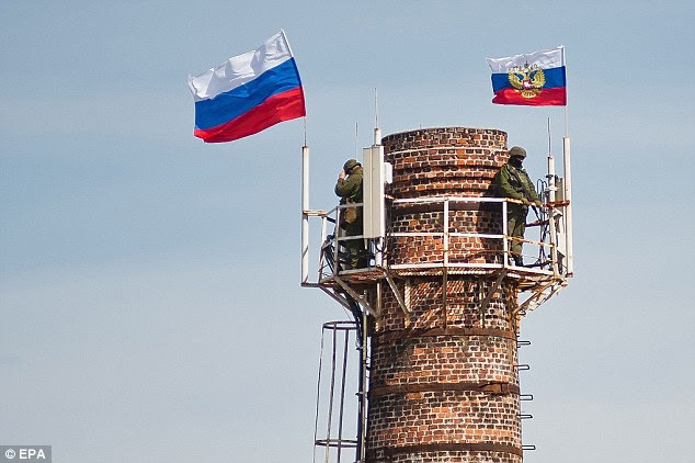 Sending a message: Russian flags fly at the top of a chimney near the territory of a Ukrainian military unit in Sevastopol